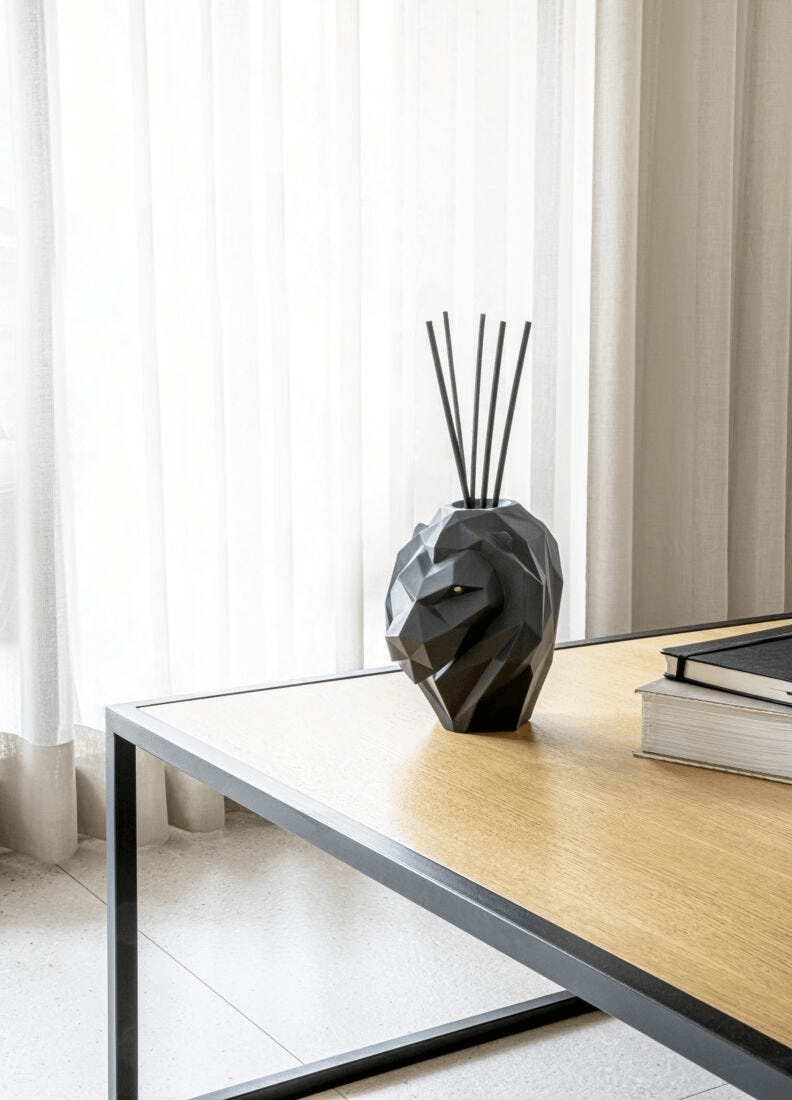 Lladró - Lion Perfume Diffuser - Unbreakable Spirit Scent showcased on a table, handcrafted porcelain design in matte black.