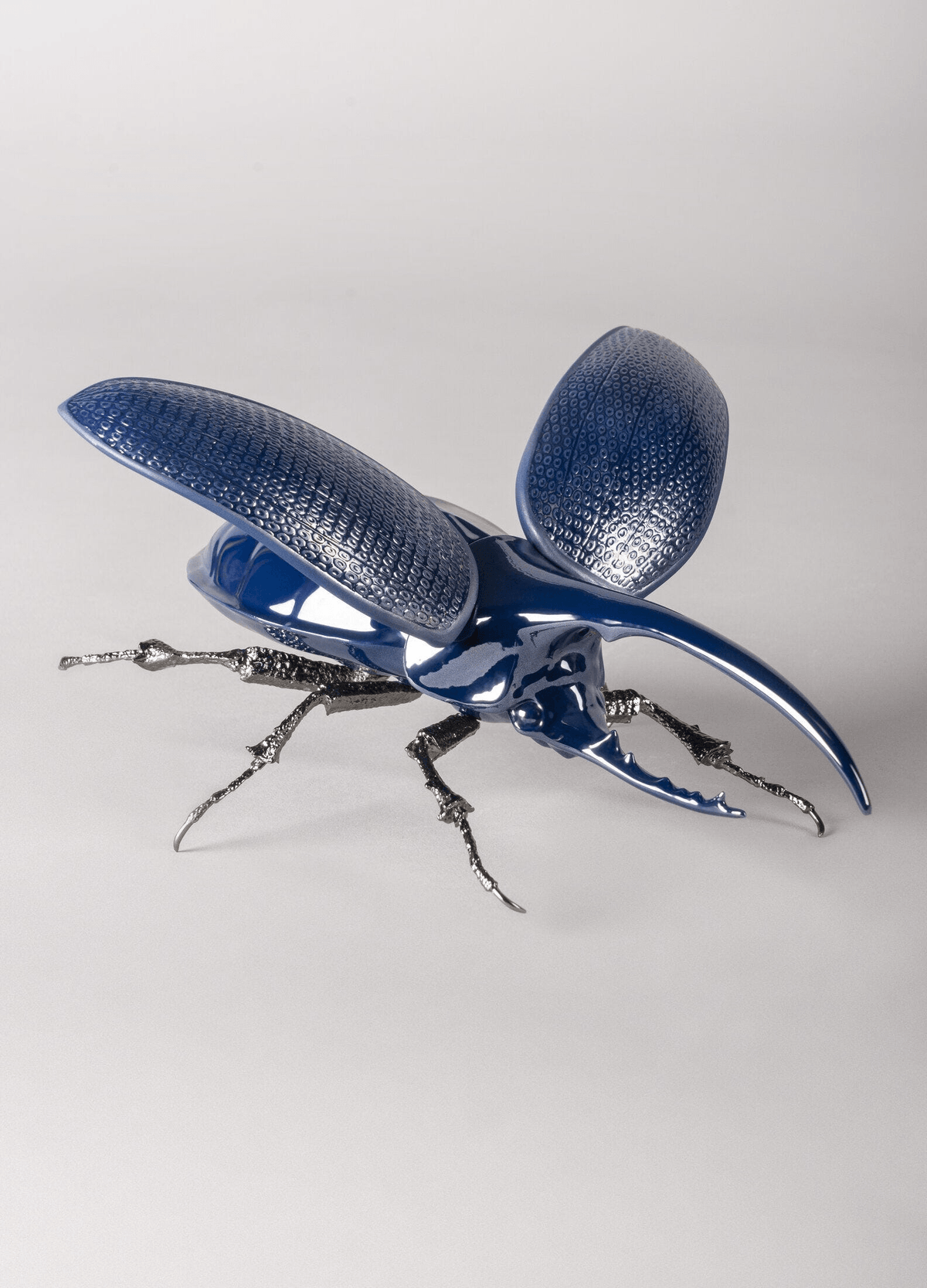 Lladró - Hercules Beetle Figurine in blue glazed porcelain with brass legs, perfect for collectors.