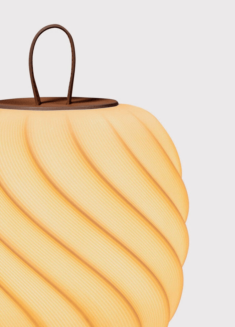 Glowing Lladro Porcelain details on the Lladró - Ice Cream Portable Lamp - Medium - Leather with a brown handle.