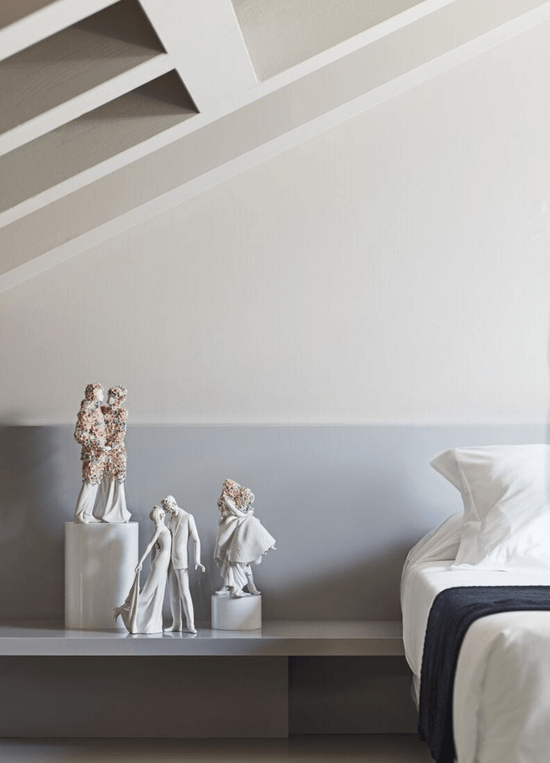 Lladró - Love I (Blossoms) - Sculpture displayed on a shelf in a modern bedroom, showcasing intricate porcelain design.