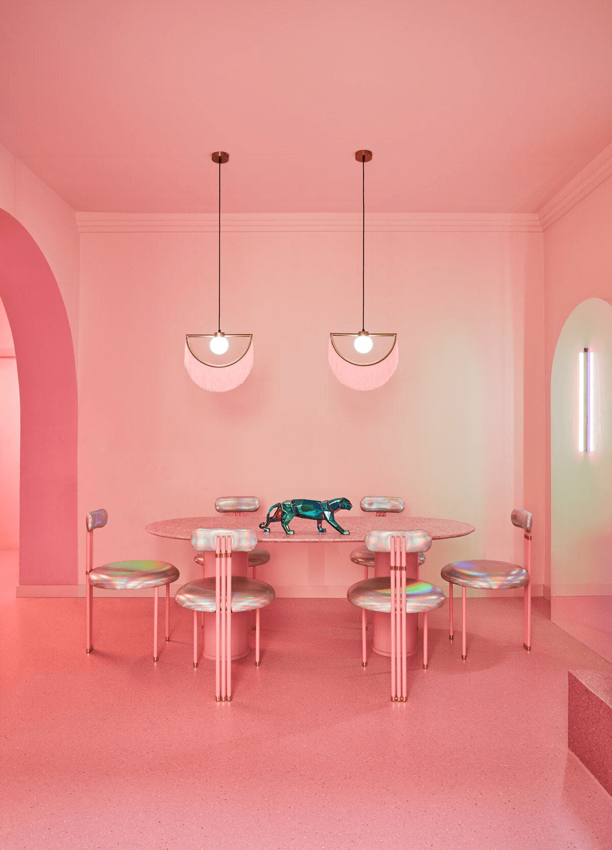 Lladró - Panther Sculpture - Iridiscent displayed on a modern pink dining table in a chic interior.