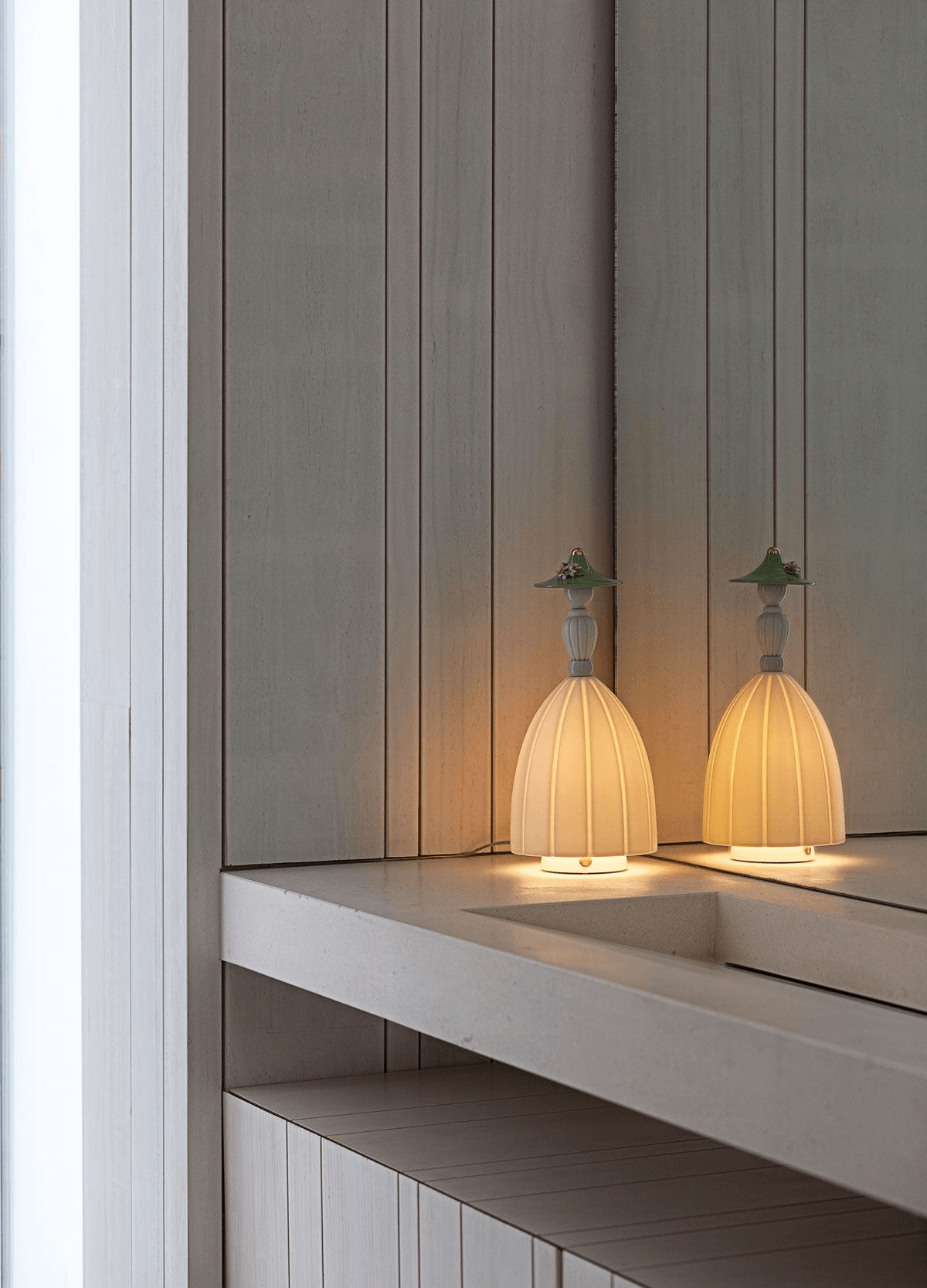 Lladró - Mademoiselle Table Lamp - Daniela crafted from Lladro Porcelain on a modern bathroom counter.