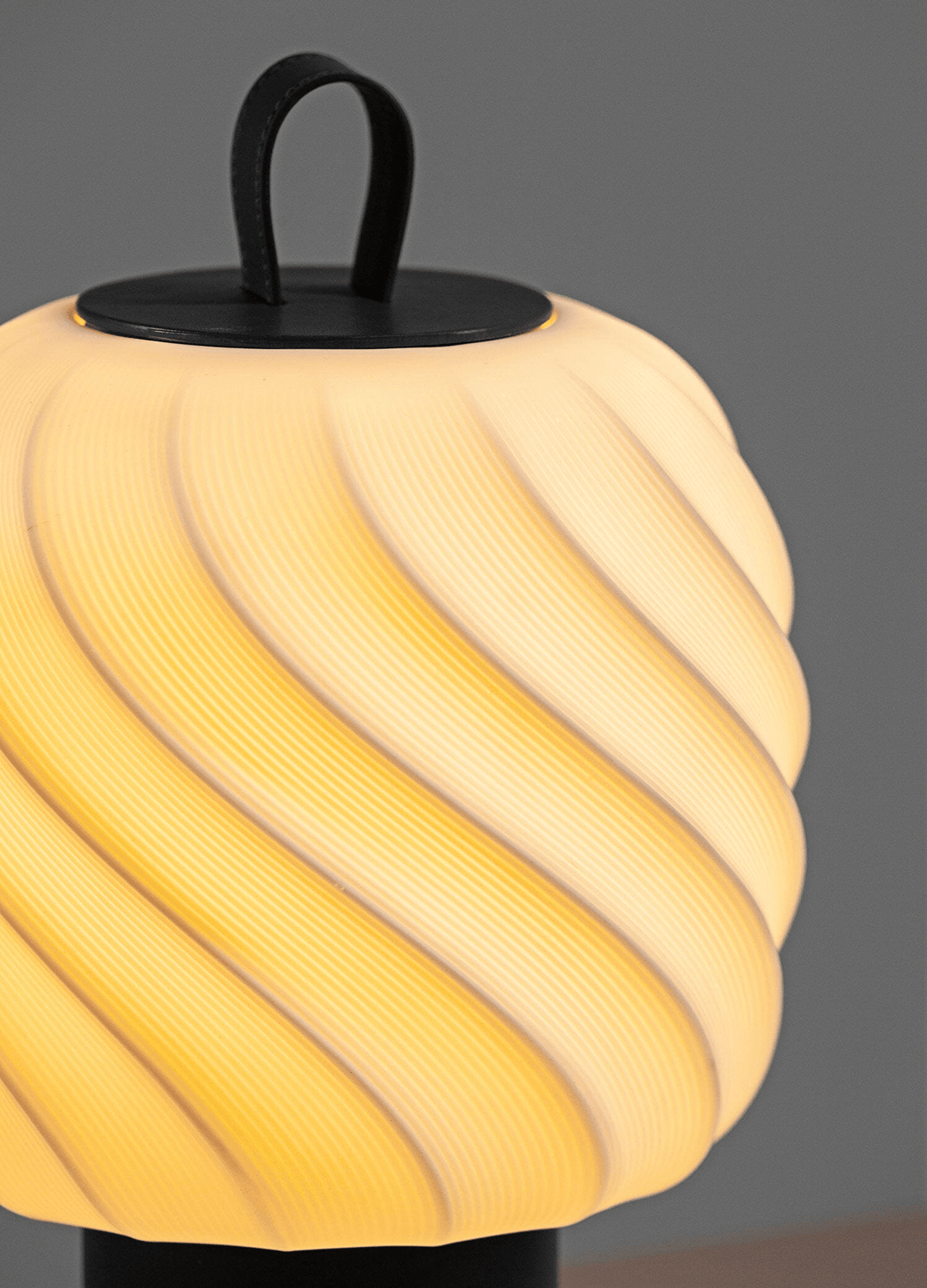 Glowing Lladro Porcelain texture on the Lladró - Ice Cream Portable Lamp - Medium - Black with leather handle.