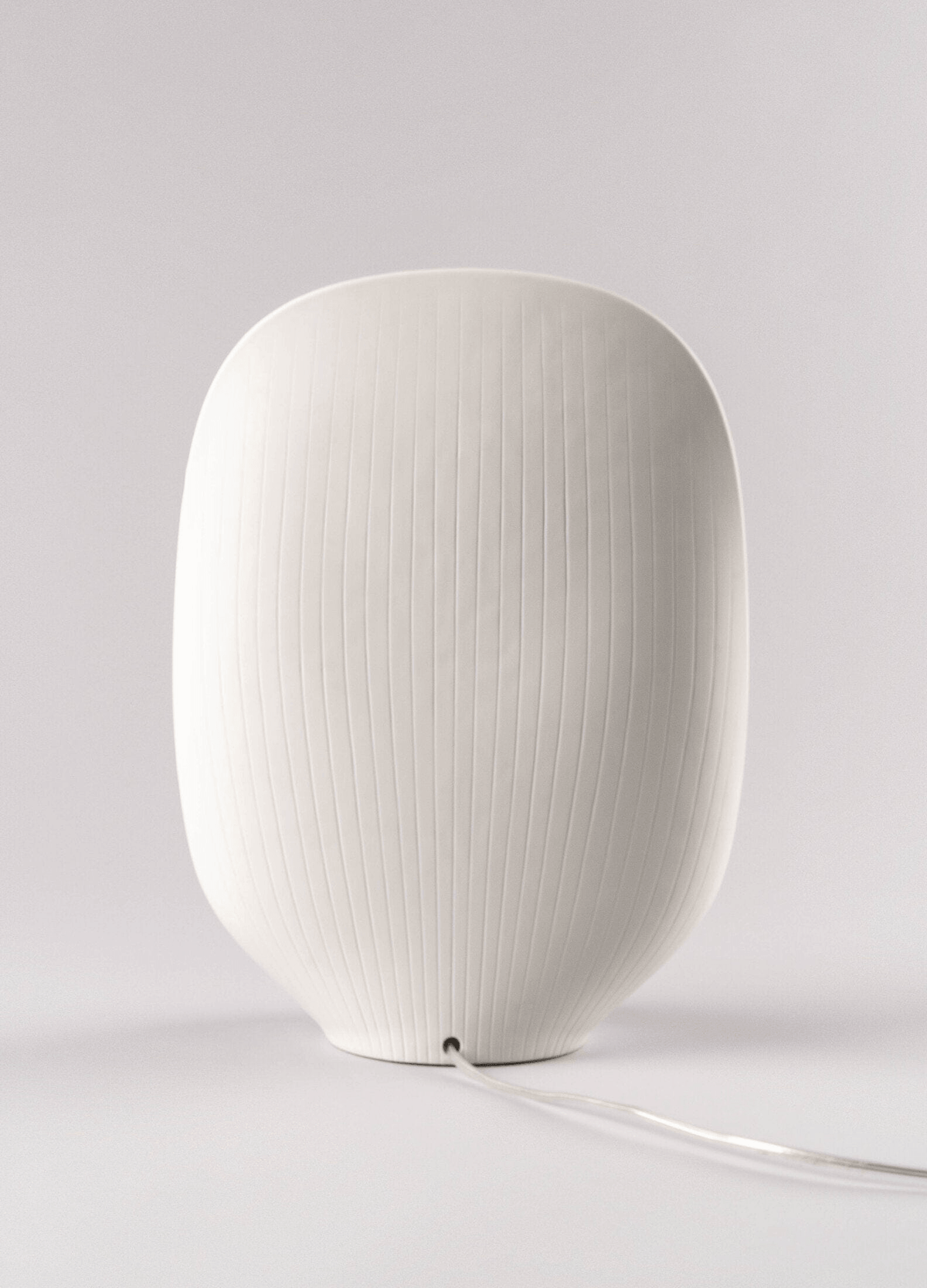 Lladró - Mirage Table Lamp in white matte porcelain with a ribbed texture and stylish design, perfect for elegant interiors.