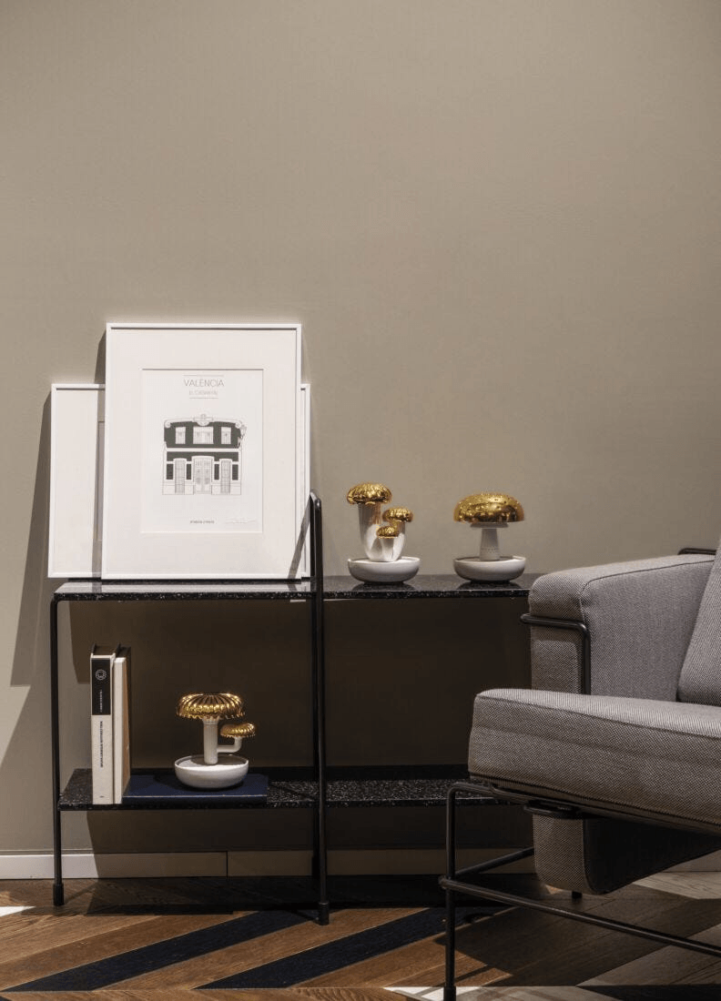 Stylish living space featuring a Lladró diffuser and framed wall art in a modern setting.