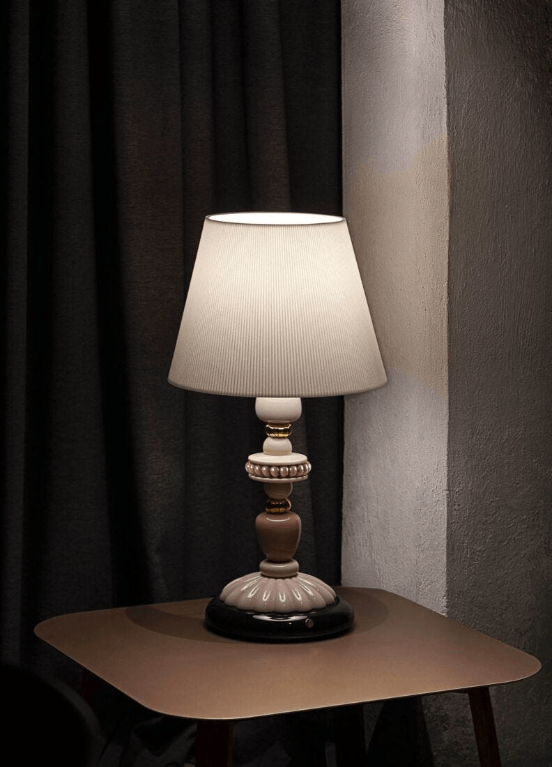 Lladró - Firefly Table Lamp - Pink and Gold elegantly displayed with soft lighting and a contemporary design.