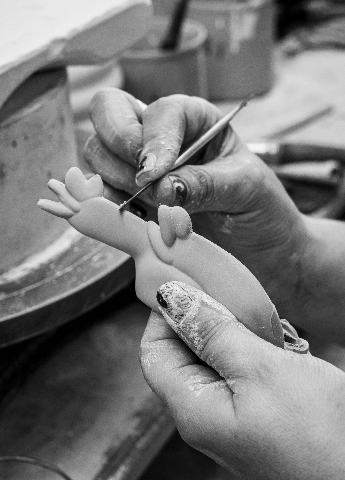 Artist shaping porcelain for Lladró - Snoopy™ Flying Ace Figurine, showcasing the intricate crafting process.