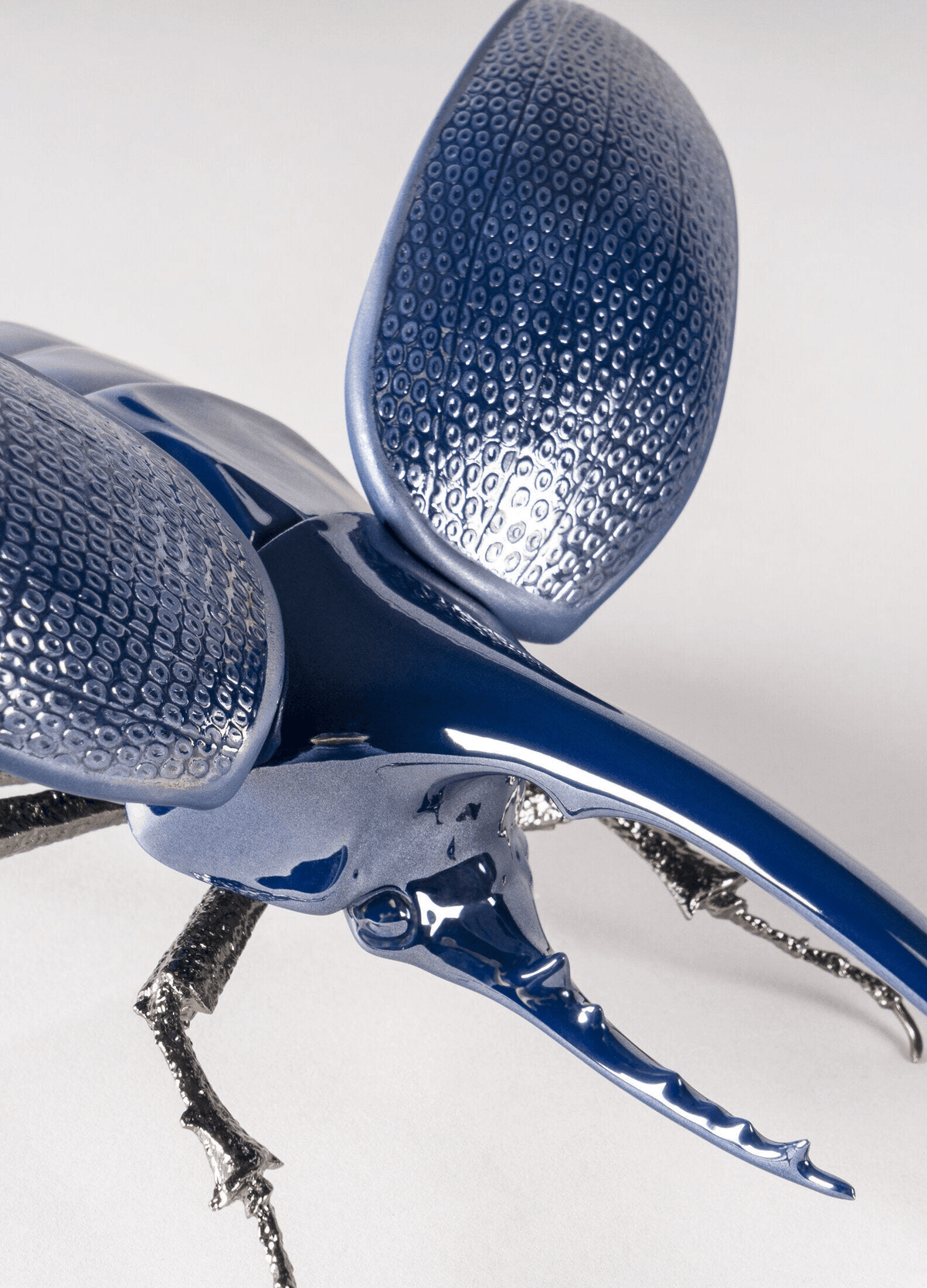 Lladró - Hercules Beetle Figurine made of glazed porcelain with brass legs, blue glossy finish.