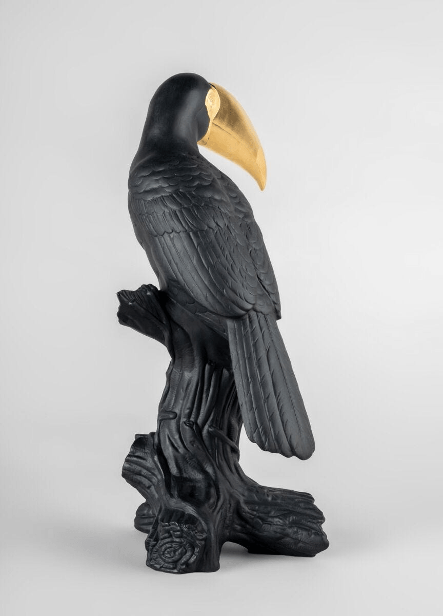 Lladró - Toucan Sculpture - Black-gold - Limited Edition in porcelain, showcasing intricate detailing and a striking color contrast.