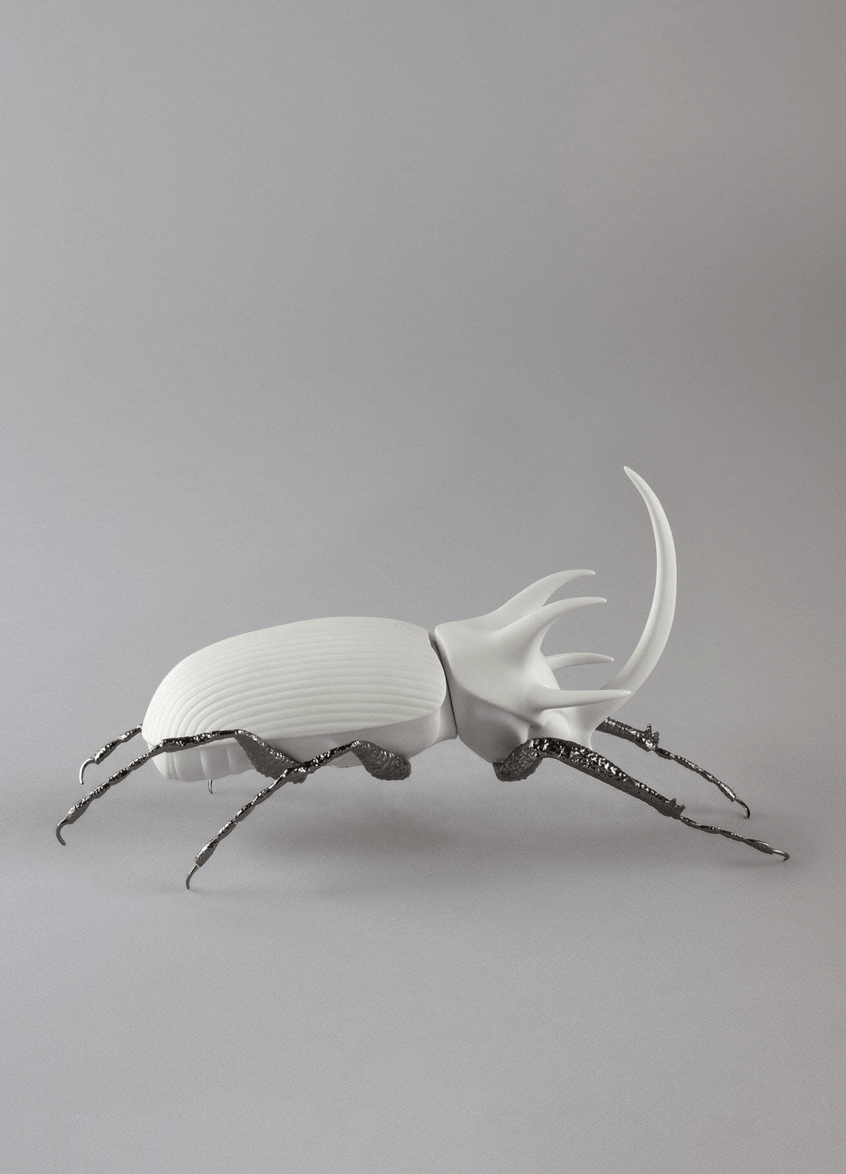 Lladró - Rhinoceros Beetle Figurine - Matte White handcrafted porcelain art piece with brass legs.