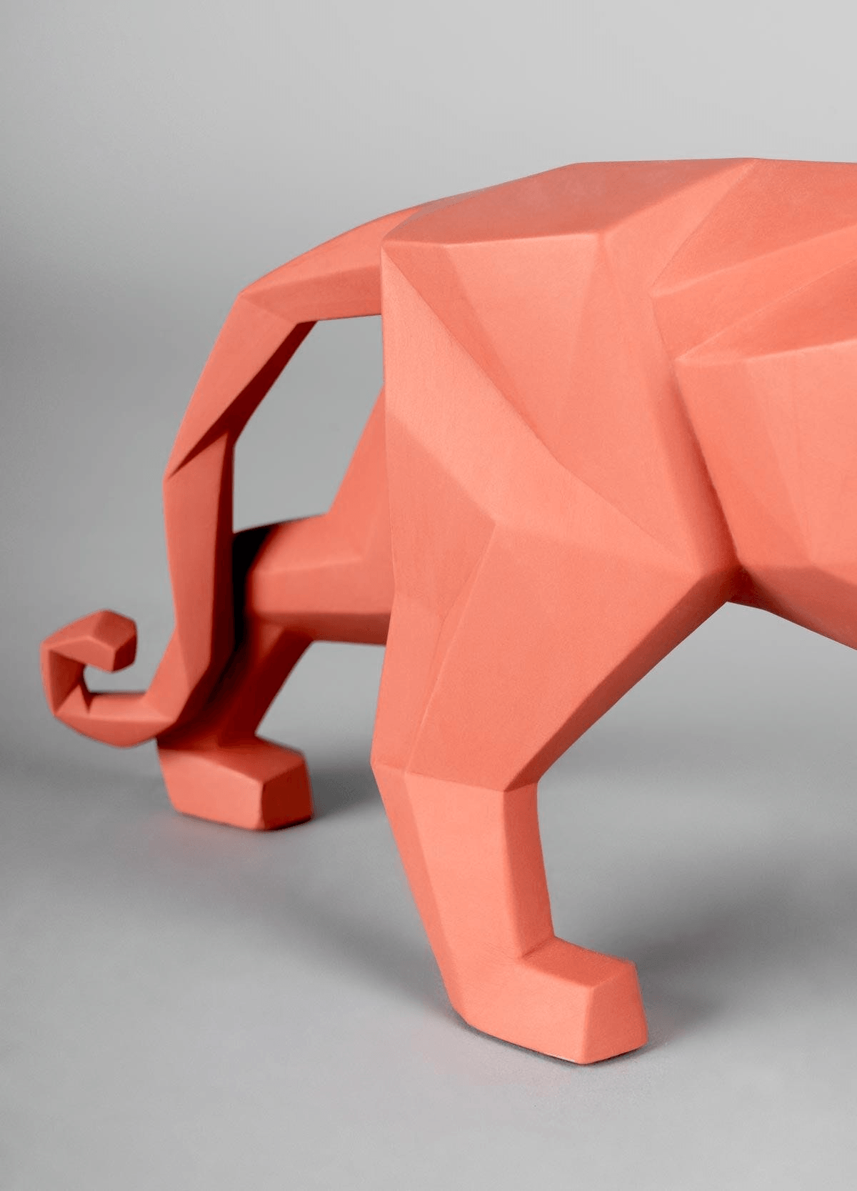 Lladró - Panther Sculpture - Coral Matte shown in geometric coral porcelain design.