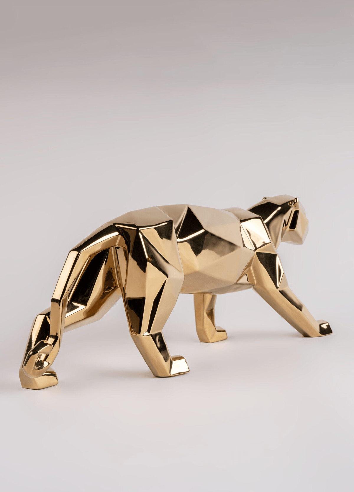 Lladró - Panther Sculpture - Golden in a sleek golden metallic finish, showcasing geometric origami design.