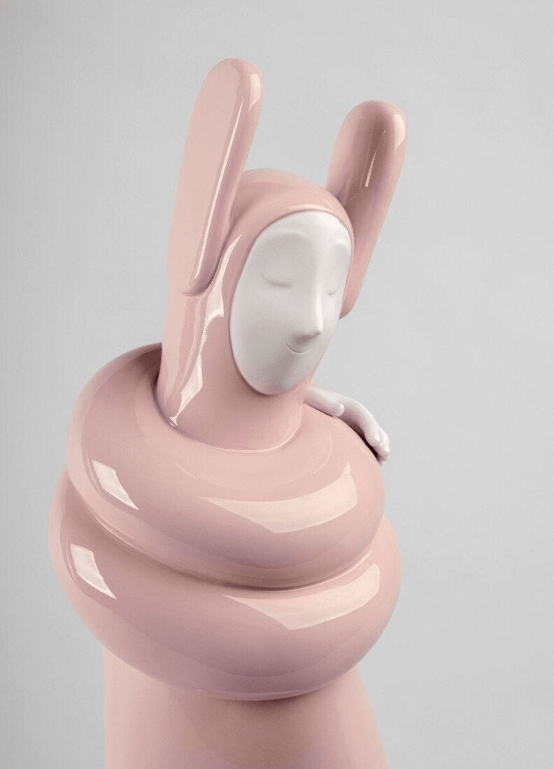 Lladró - Embraced Sculpture - Pink, porcelain figure by Jaime Hayon, representing self-care and embrace.