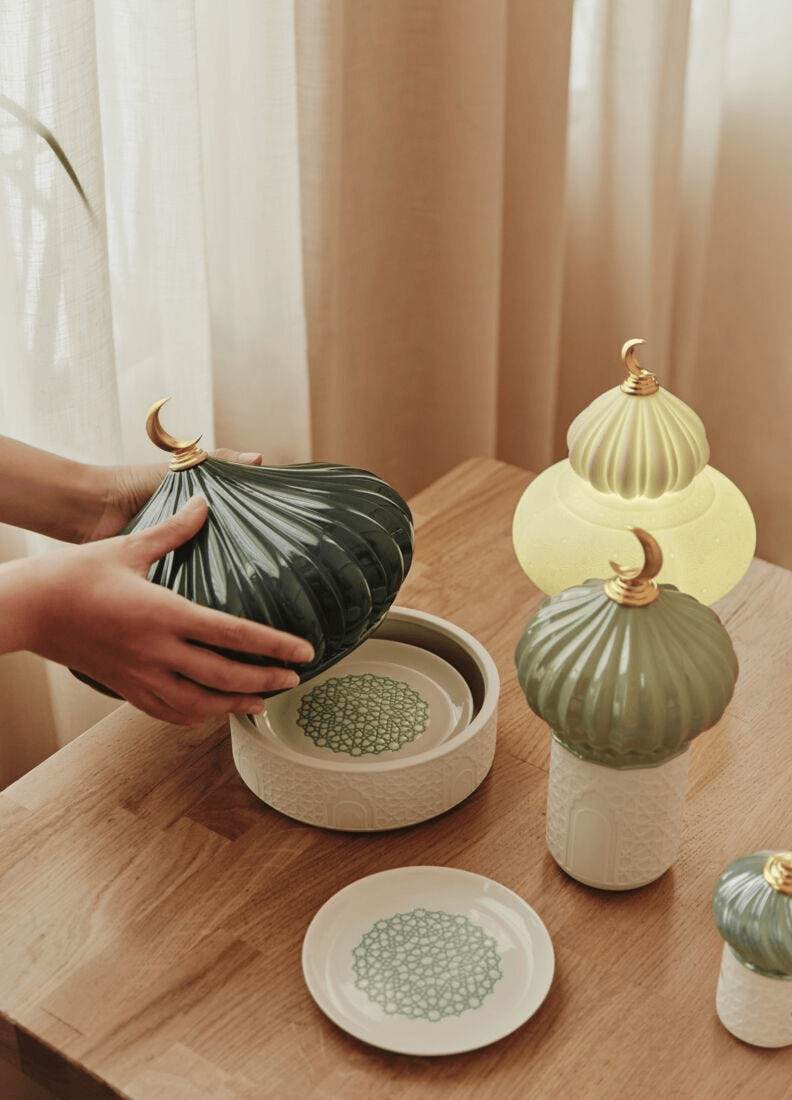 Lladró - Majestic Nights Wireless Lamp, elegant porcelain pieces with intricate designs on a wooden table.