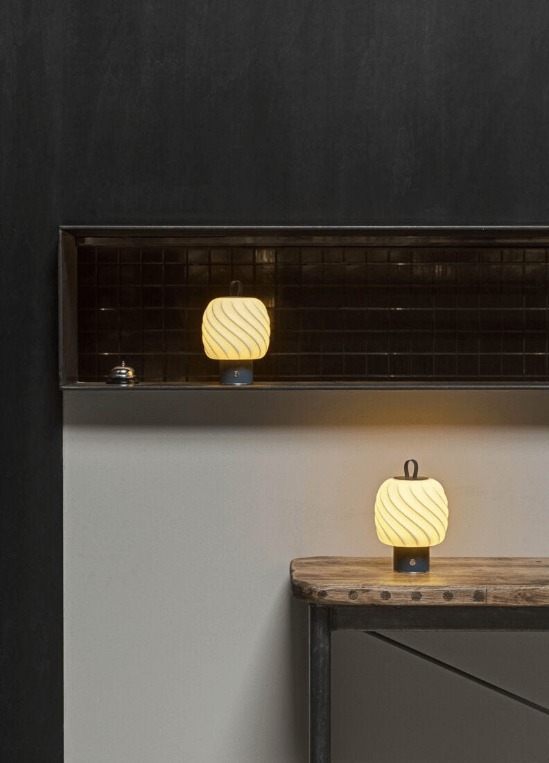 Lladró - Ice Cream portable lamp - Medium - Blue on a wooden table, glowing softly, showcasing porcelain craftsmanship.