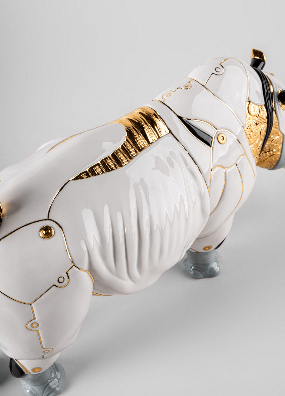 Lladró - Rhino Cyborg Sculpture featuring detailed porcelain finish and intricate golden accents.