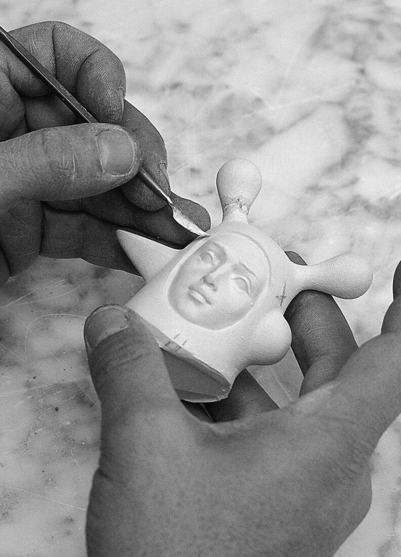 Artisan sculpting Lladró - The Lover II Sculpture from porcelain with precision tools.