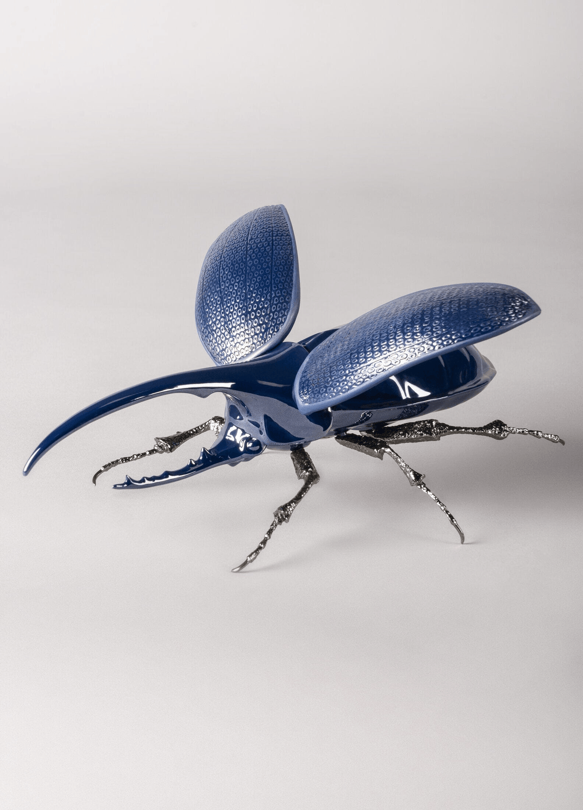 Lladró - Hercules Beetle Figurine made of porcelain, featuring blue finish and brass legs, perfect for collectors.