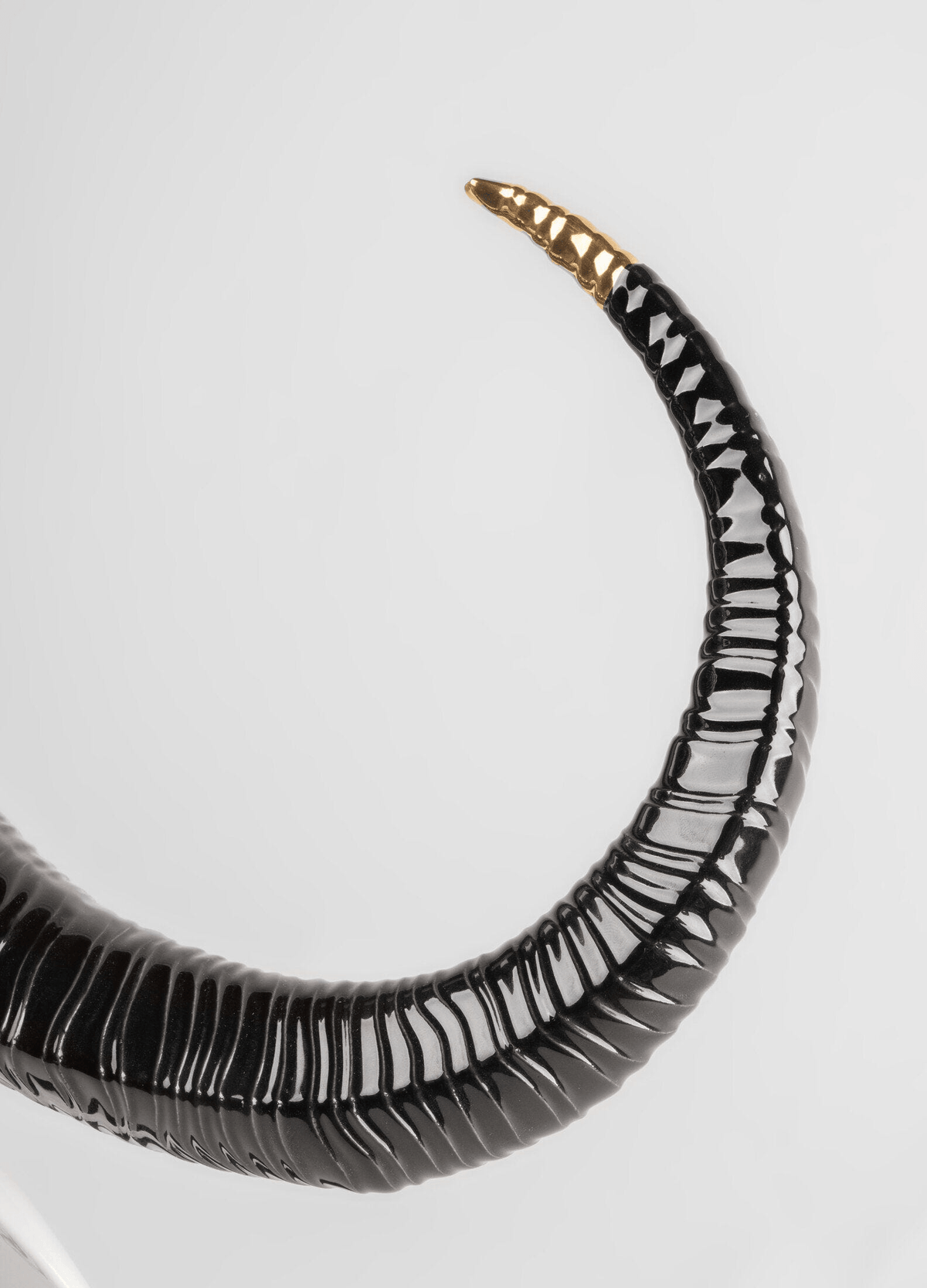Lladró - Buffalo Mask - Black and Gold detail of black porcelain horn with gold accents