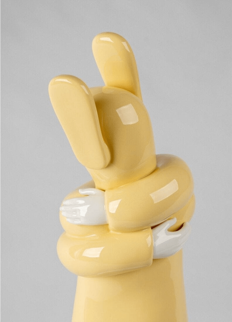 Lladró - Embraced Sculpture - Yellow, porcelain sculpture by Jaime Hayon, symbolizing self-care and embrace.