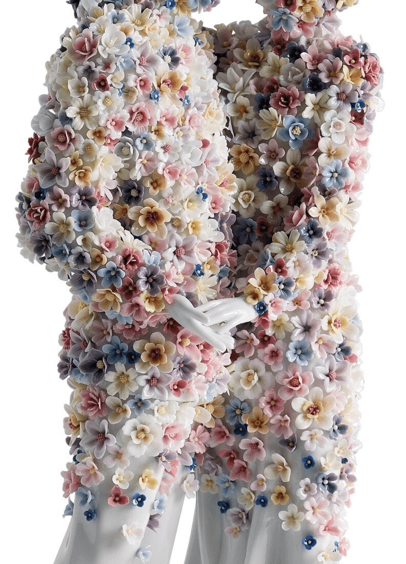 Lladró - Love III (blossoms) Sculpture featuring intricately detailed porcelain flowers adorning a romantic couple.