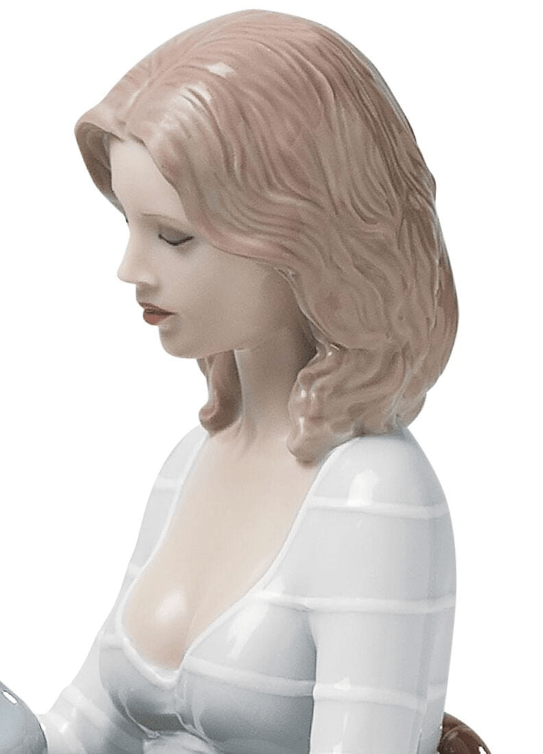 Lladró - The Family Portrait Sculpture, porcelain figurine of a woman with detailed features and hairstyle.