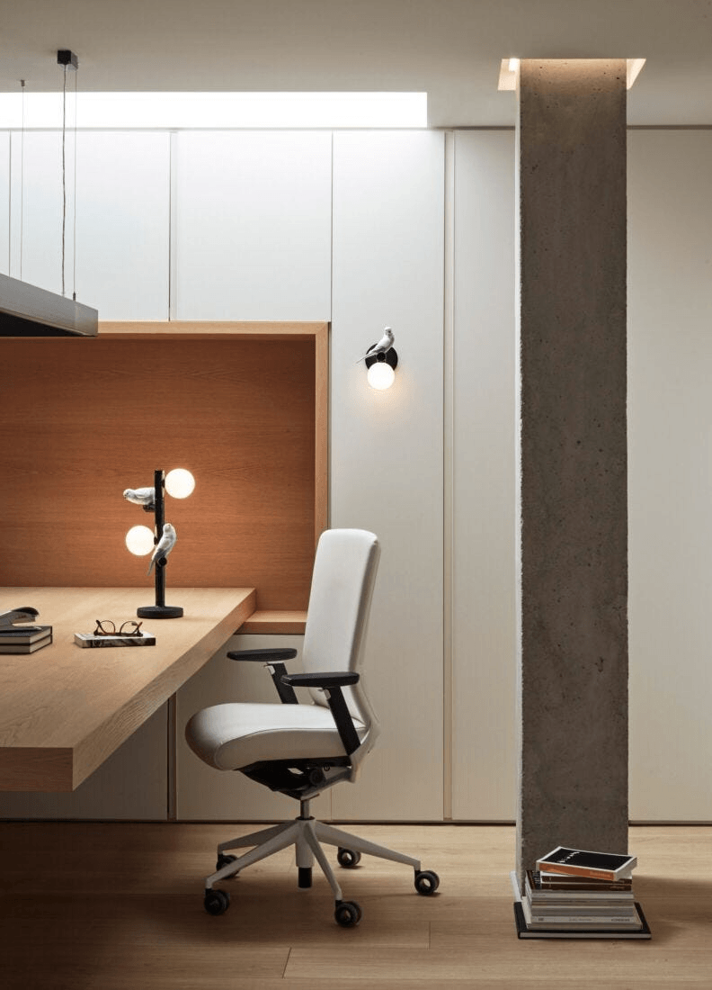 Lladró - Parrot Wall Sconce - Black illuminating a modern office space with elegant design.