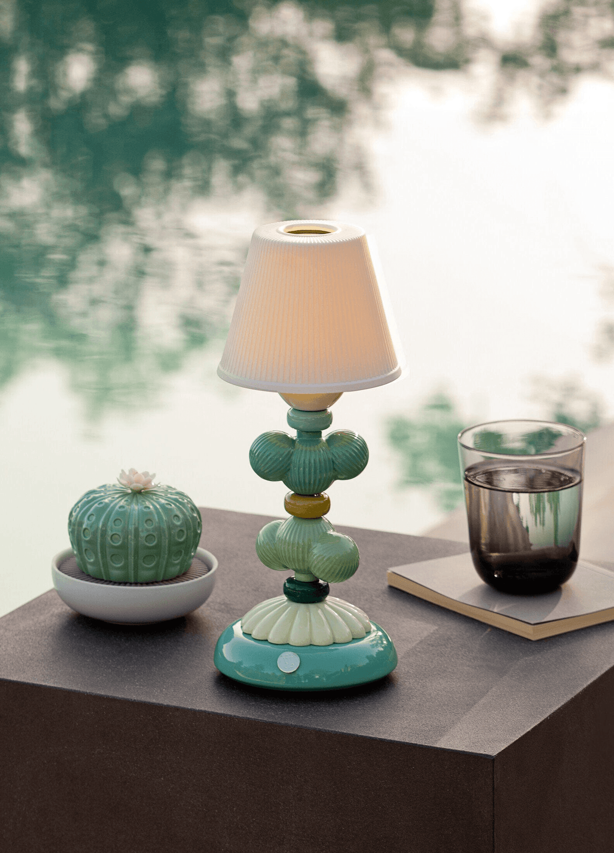Lladró - Cactus Firefly Table Lamp - Green in Lladro porcelain. Wireless outdoor lamp by a pool.