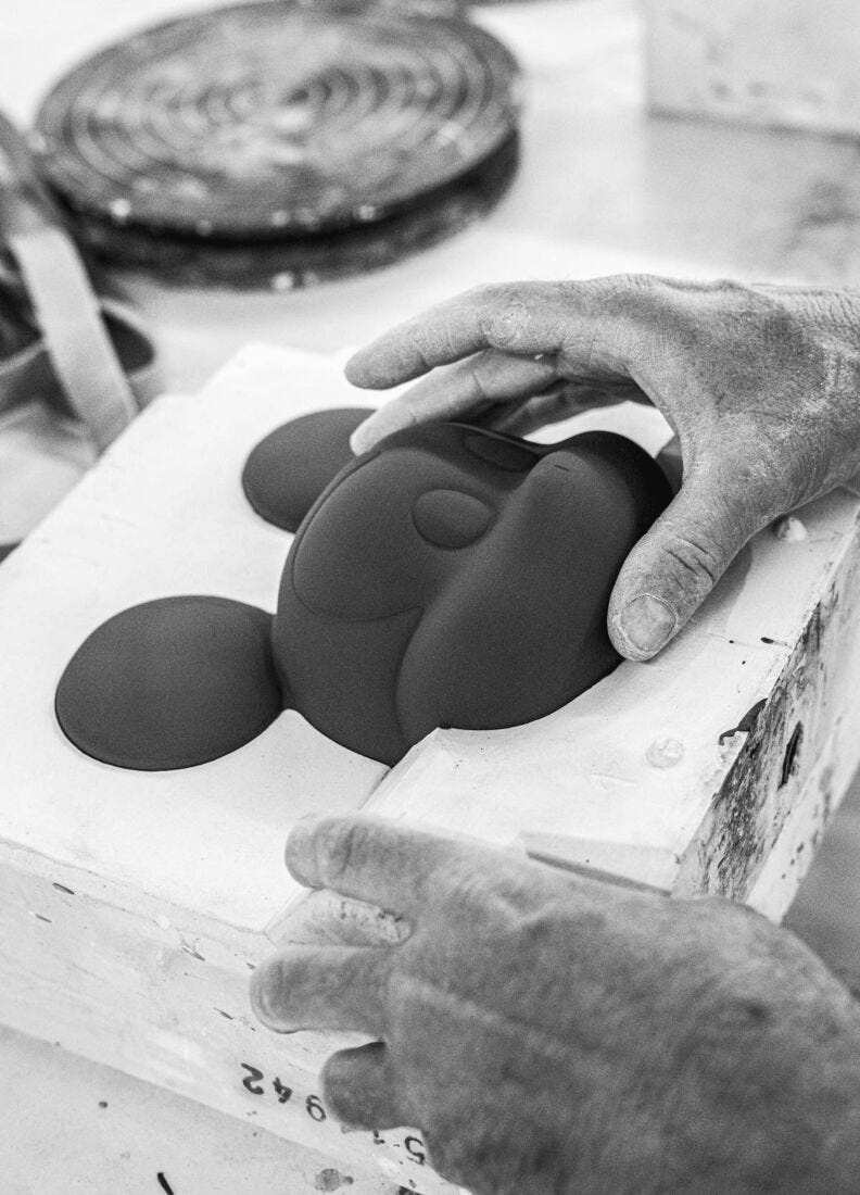 Lladró - Mickey Total Black Sculpture being crafted in porcelain, showcasing artistry and creativity.