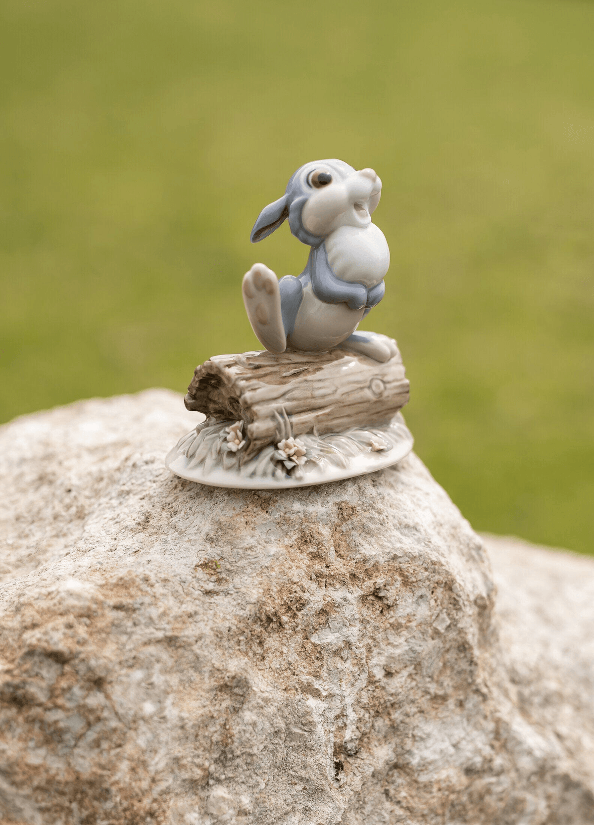 Lladró - Thumper Figurine of a smiling rabbit on a log, crafted in porcelain, ideal for collectors.