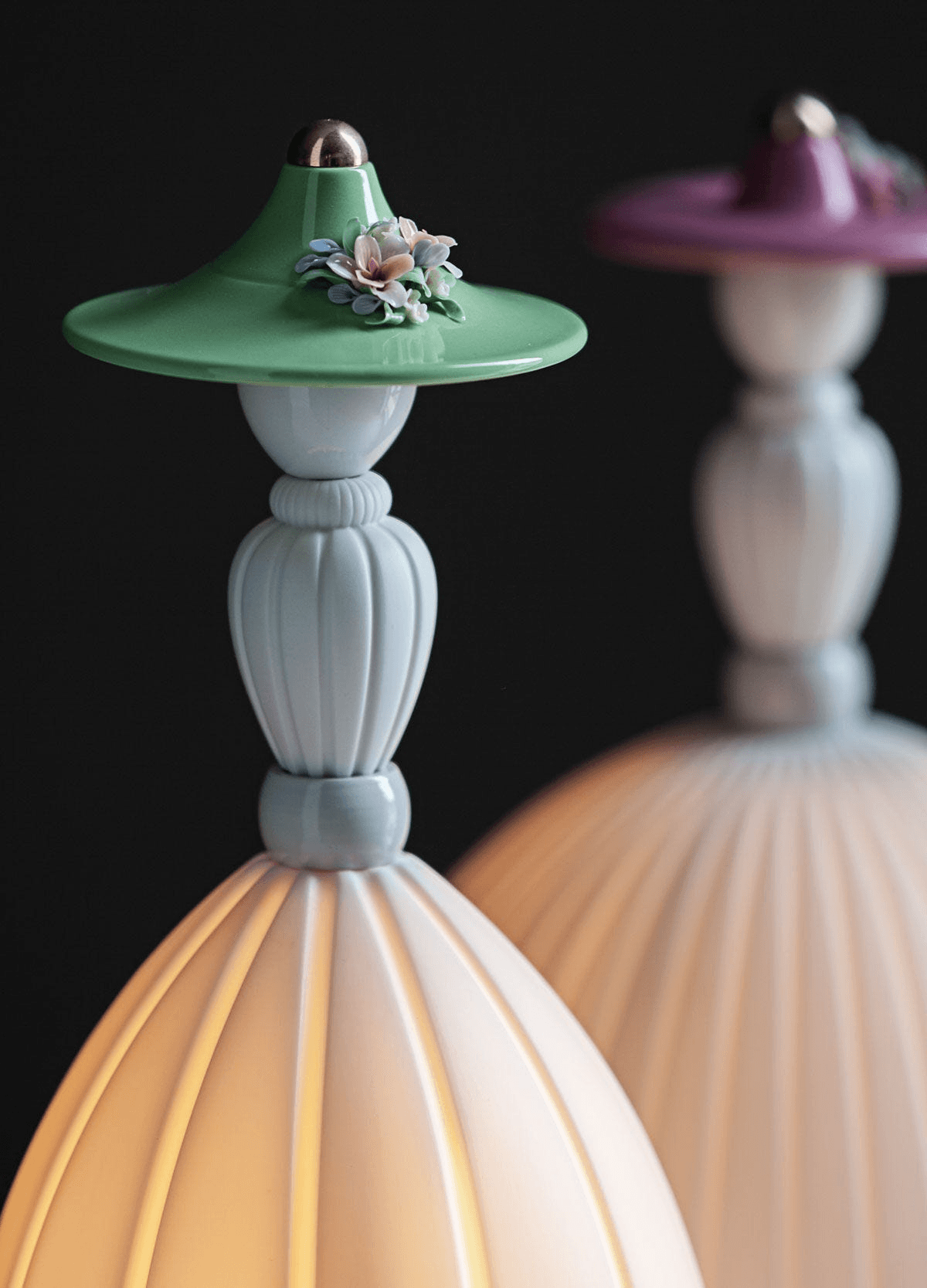 Lladró - Mademoiselle Table Lamp - Daniela in Lladro Porcelain, featuring a lady with a green floral hat and glowing base.