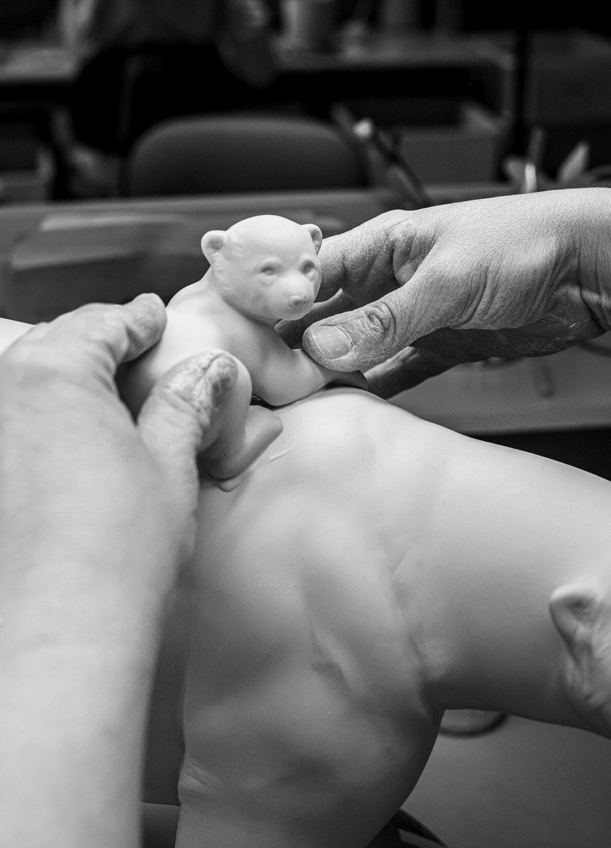 Lladró - Mummy bear and babies - Underwater Sculpture being crafted in porcelain with hands shaping the details.