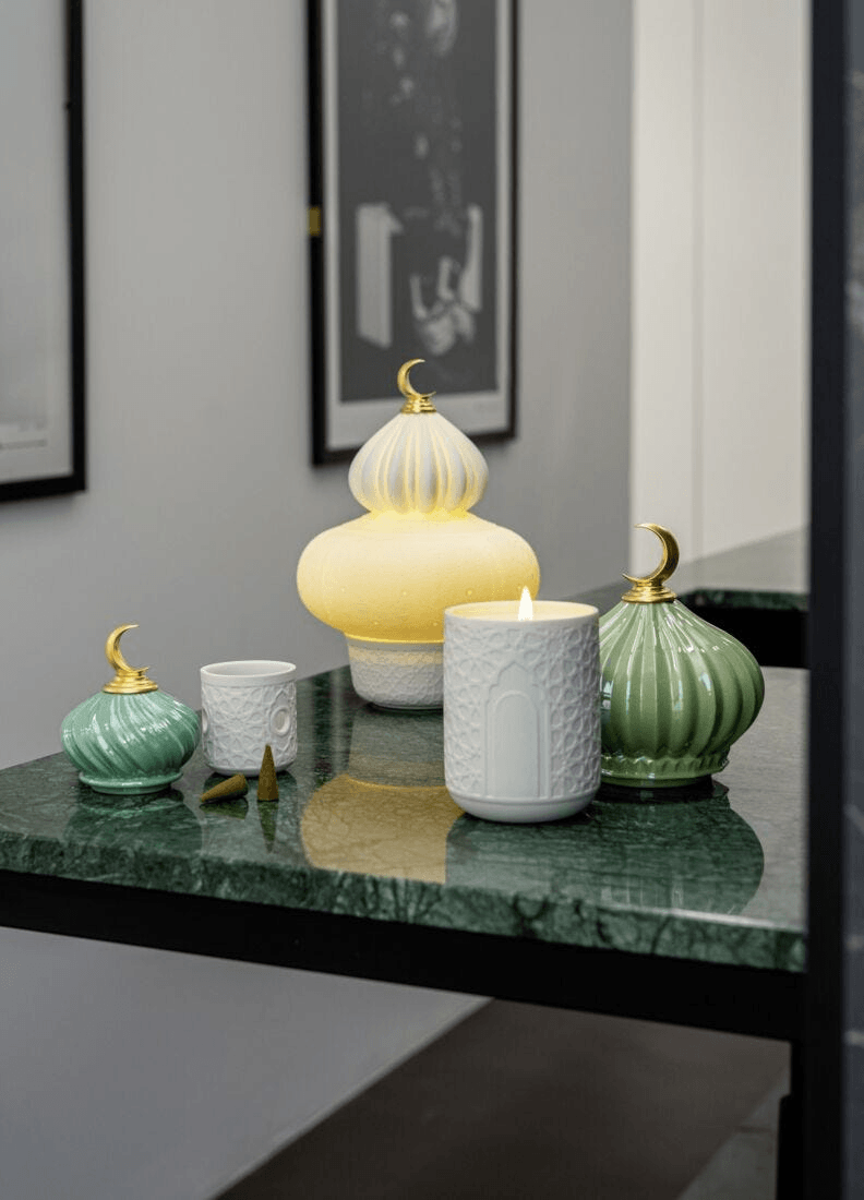 Lladró - Majestic Nights Wireless Lamp displayed on a green marble table with other decorative porcelain items.