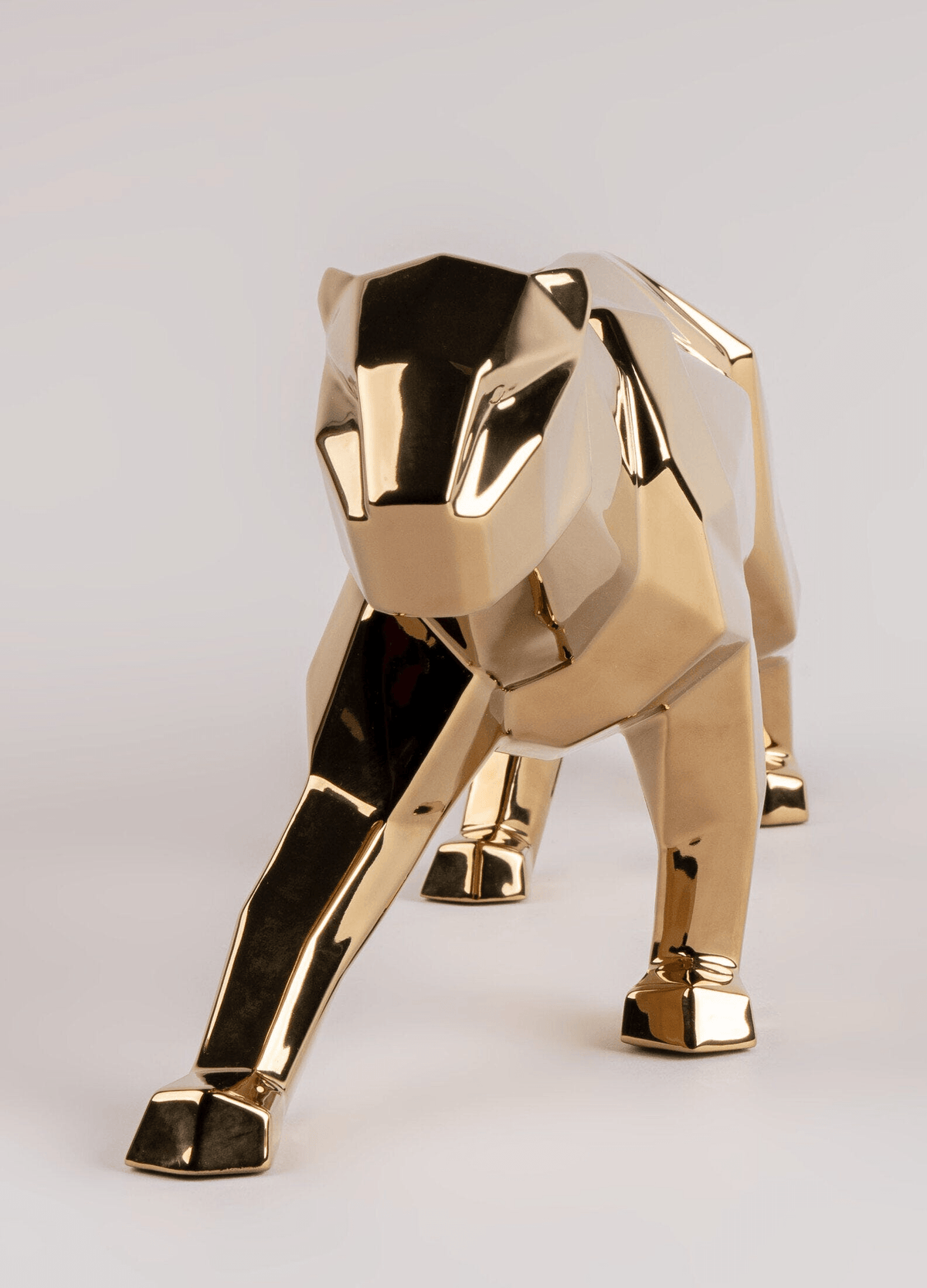 Lladró - Panther Sculpture - Golden, elegant golden porcelain figurine showcasing contemporary origami design.