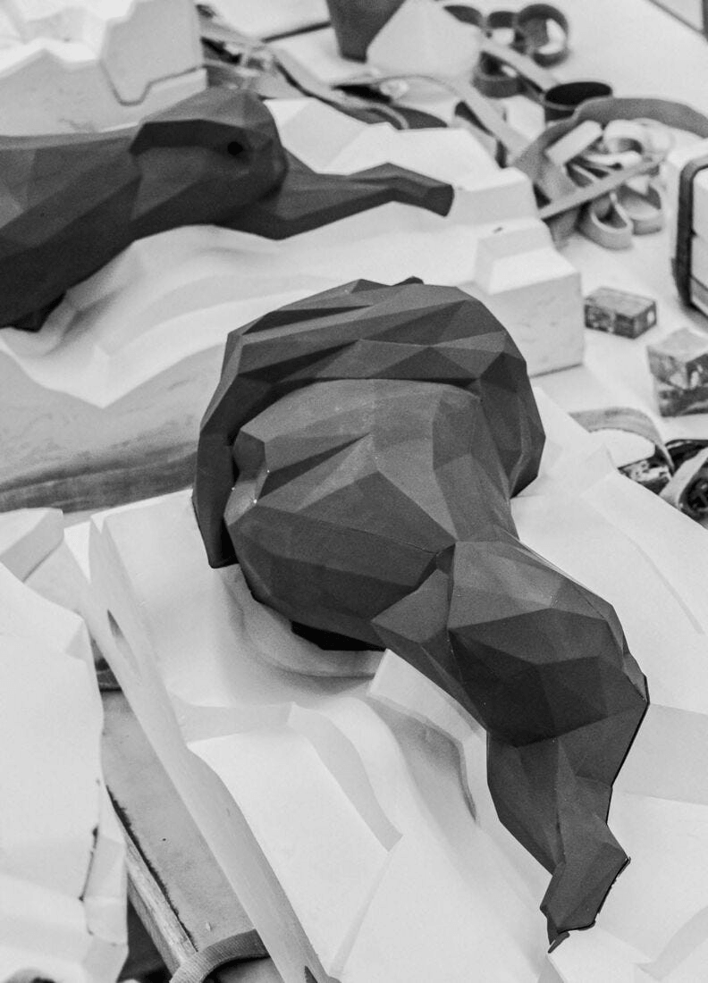 Lladró - Lion Sculpture - Matte Black in production, showcasing geometric origami-inspired design and porcelain craftsmanship.