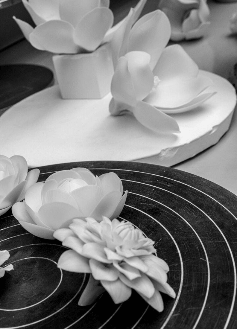 Lladró - Bouquet Wall Sconce crafted porcelain flowers in a black and white setting, showcasing delicate and elegant designs.