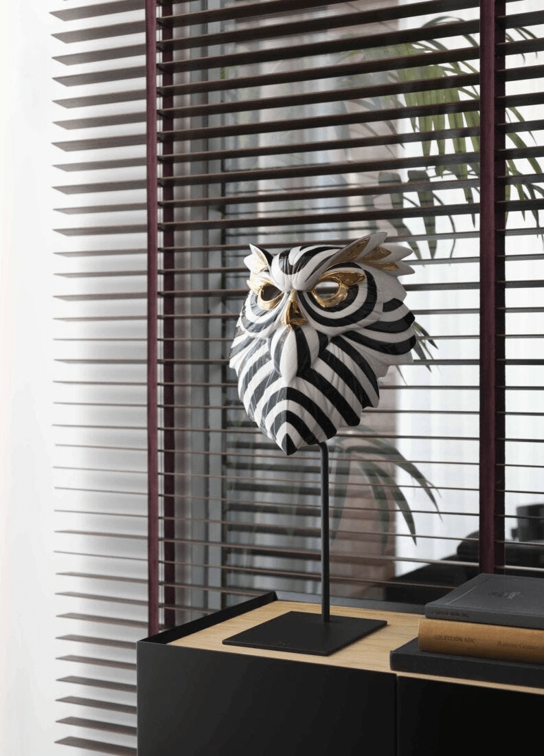 Lladró - Owl Mask - Black and Gold decorated with black lines and golden luster, displayed on a stand.
