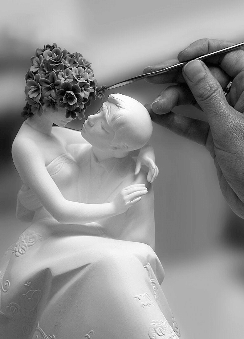 Artisan creating Lladró - Love II (Blossoms) Sculpture in porcelain, capturing intricate floral details.