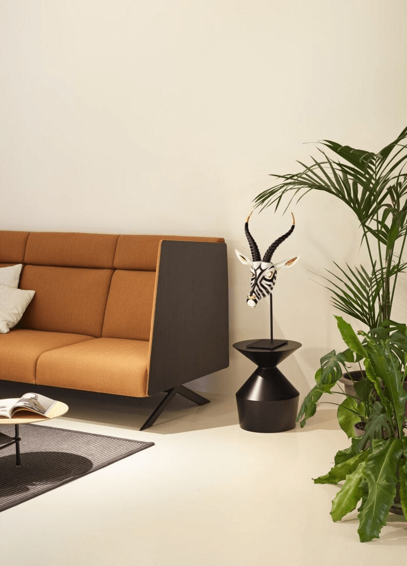 Lladró - Antelope Mask - Black and Gold displayed in a modern living room with plants and furniture.