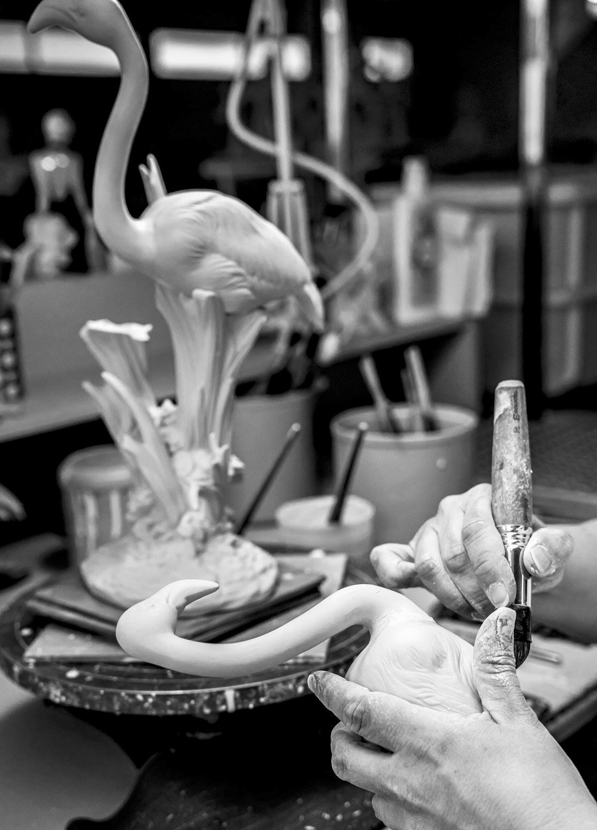 Lladró - The Flamingos Sculpture - Pink being crafted from porcelain with skilled hands at a workshop.