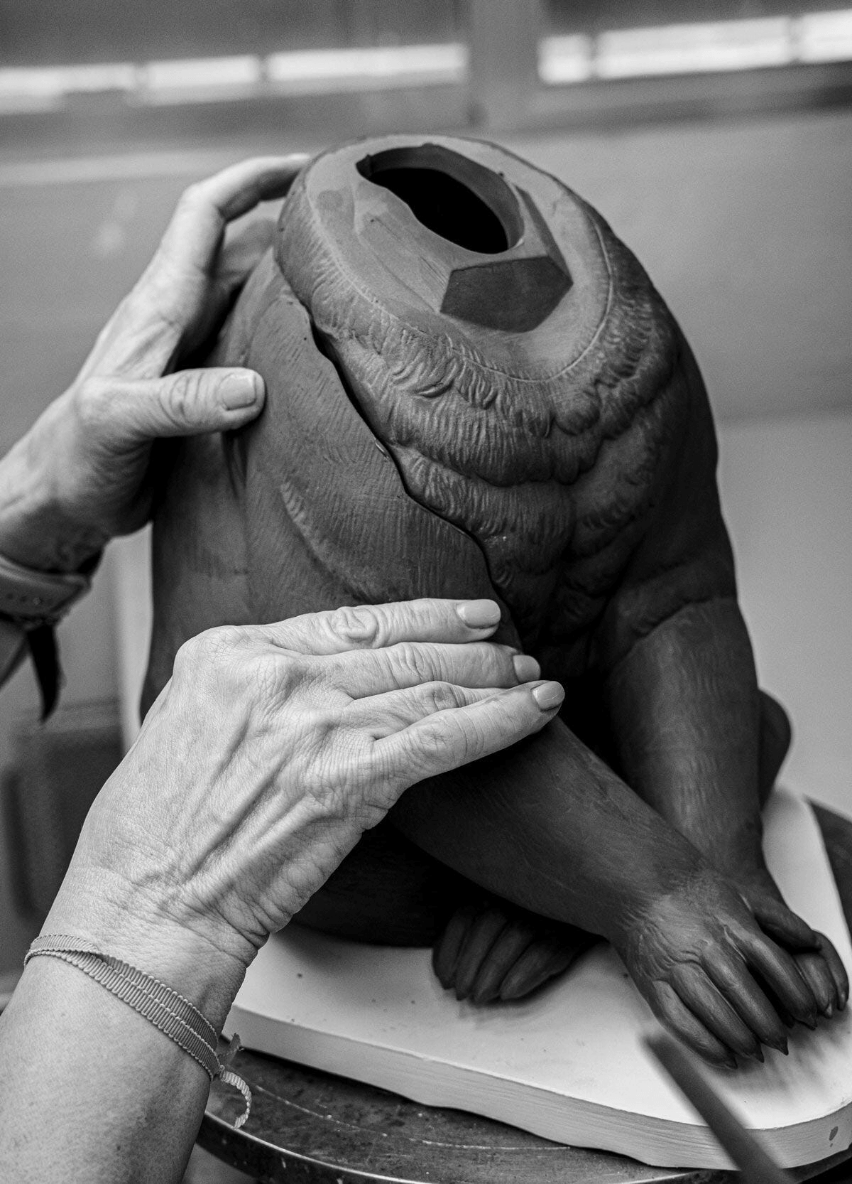 Lladró - Koala Sculpture - Black-gold - Limited Edition being crafted by an artisan, showcasing the porcelain detail