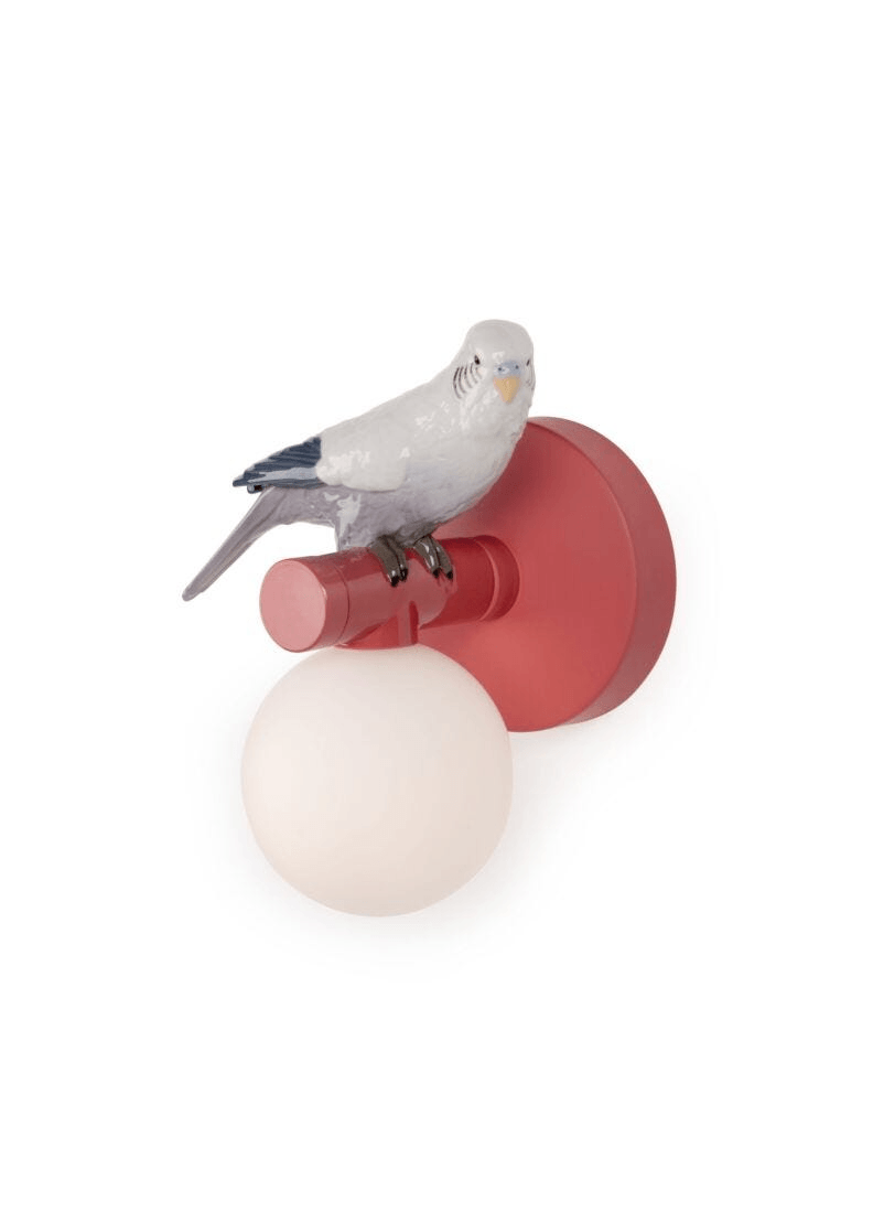 Lladró - Parrot Wall Sconce - Red featuring a porcelain bird atop a glossy red base with a frosted globe.