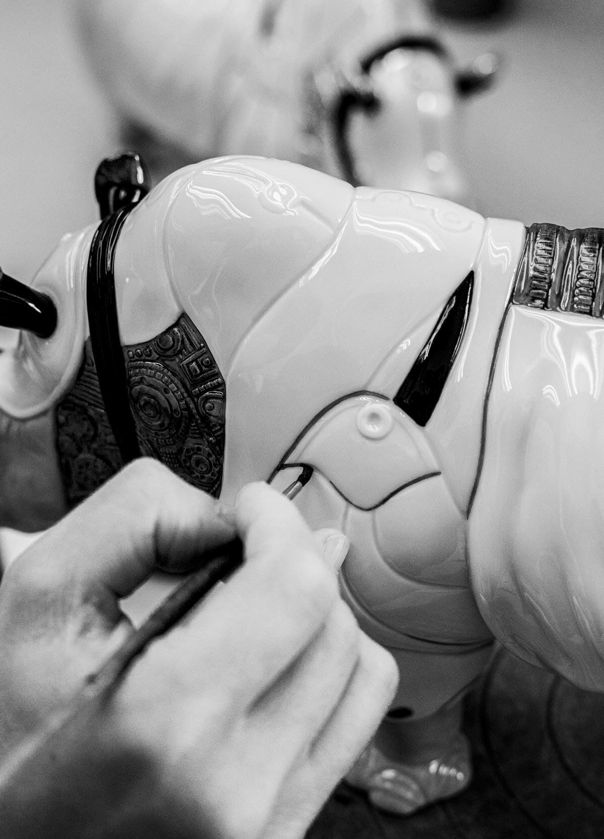 Artisan detailing the Lladró - Rhino Cyborg Sculpture, showcasing its intricate porcelain craftsmanship.