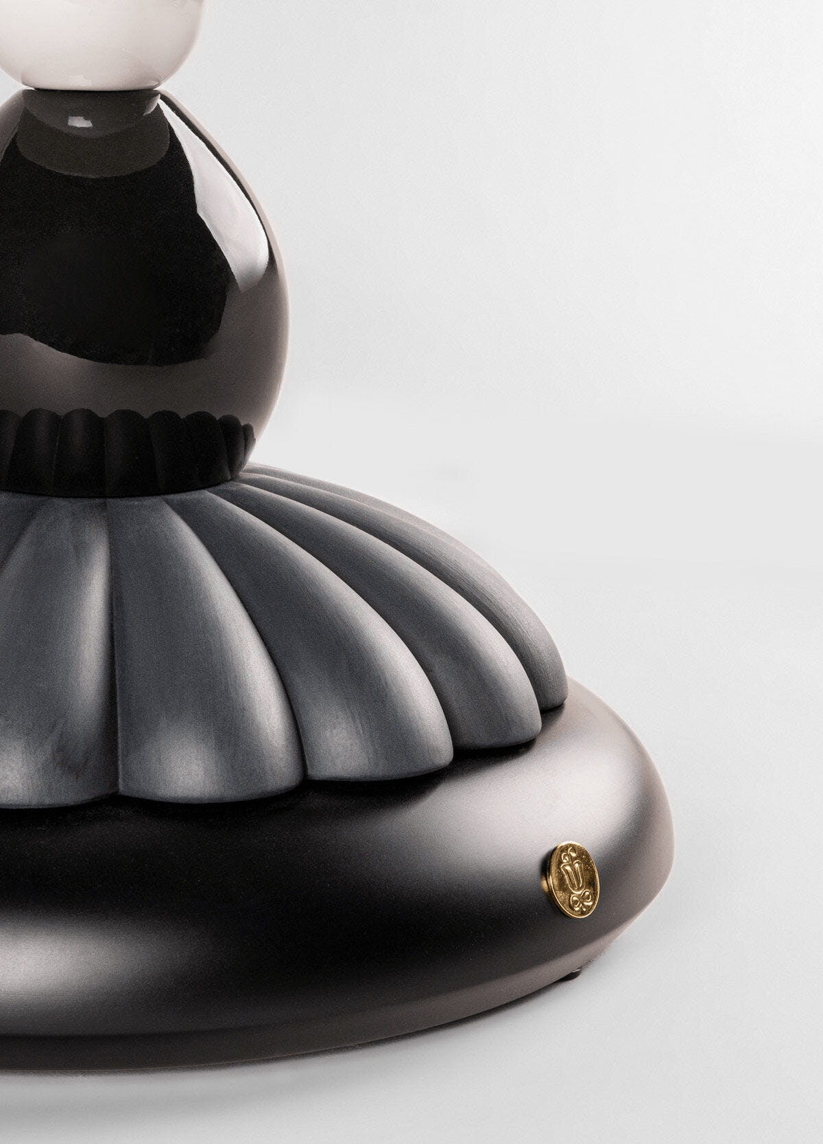 Black Lladro Porcelain base detail of the Lladró - Firefly Table Lamp by Olga Hanono with metallic accents.