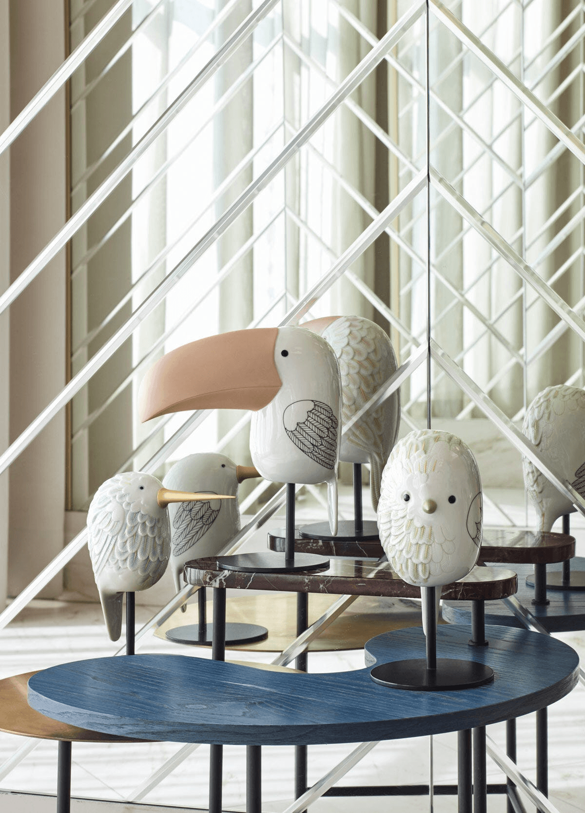 Lladró - Face 2 Face - Toucan decorative porcelain bird figurines displayed on a modern table.