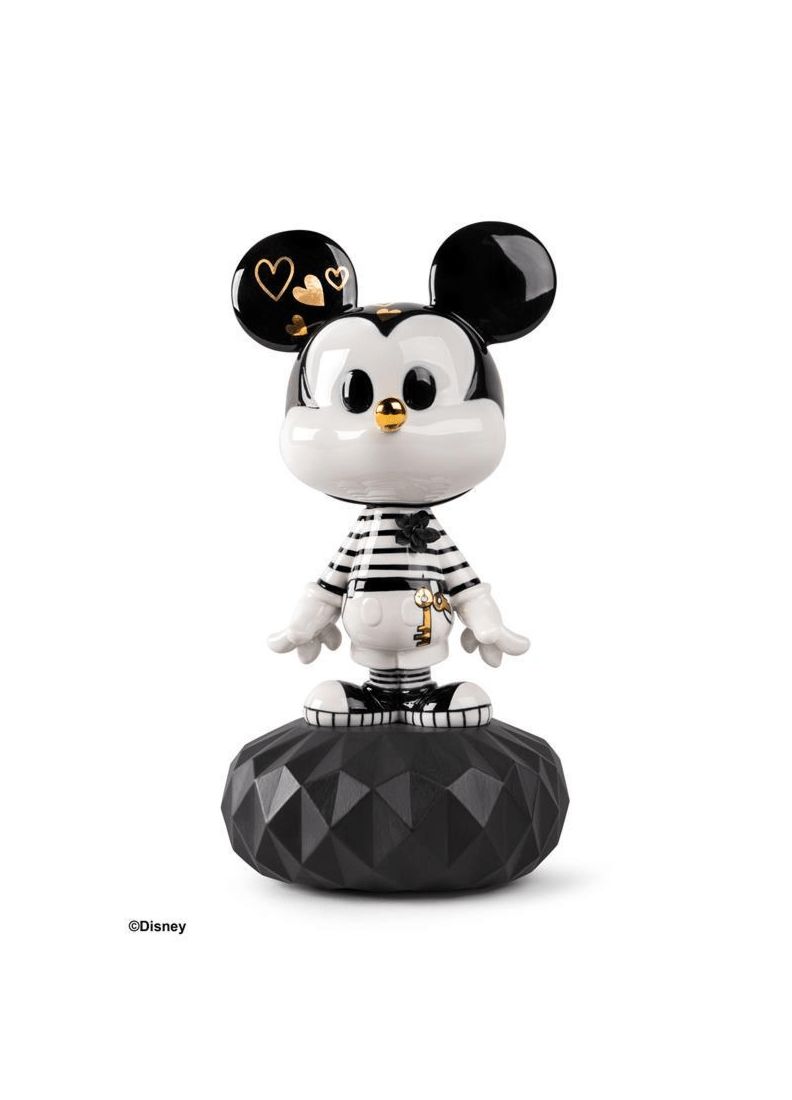 Lladró - Mickey in Black and White Sculpture displayed on a black geometric base, showcasing porcelain craftsmanship.