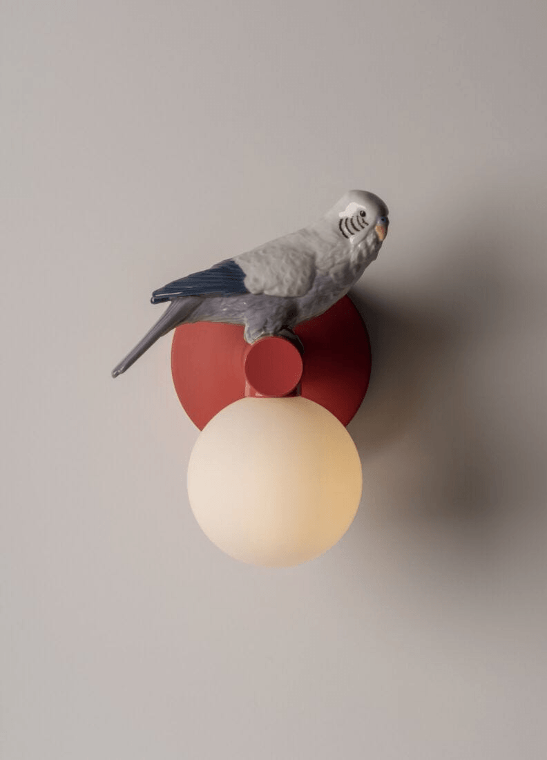 Lladró - Parrot Wall Sconce - Red featuring a porcelain parrot on a stylish wall light.