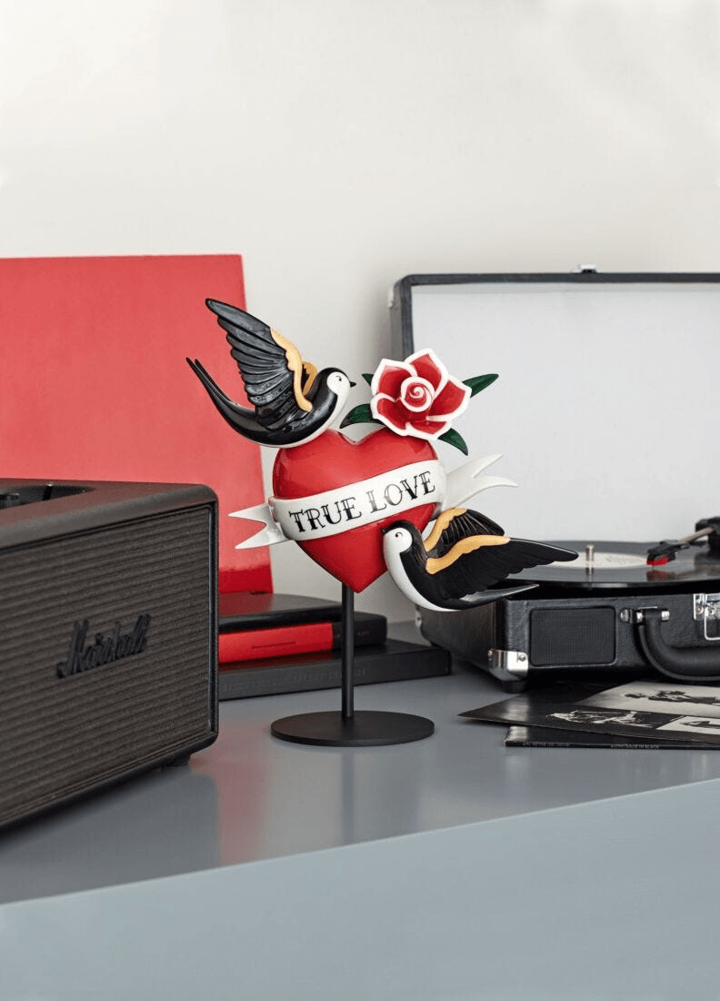 Lladró - True love Heart Figurine displayed on a table, featuring a heart, roses, and birds in vibrant colors.