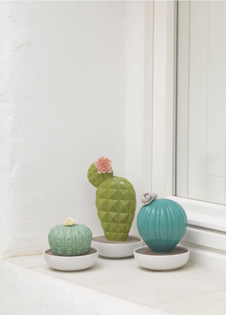 Lladró - Ferocactus Cactus Diffuser - Gardens of Valencia Scent displayed with vibrant porcelain cacti.