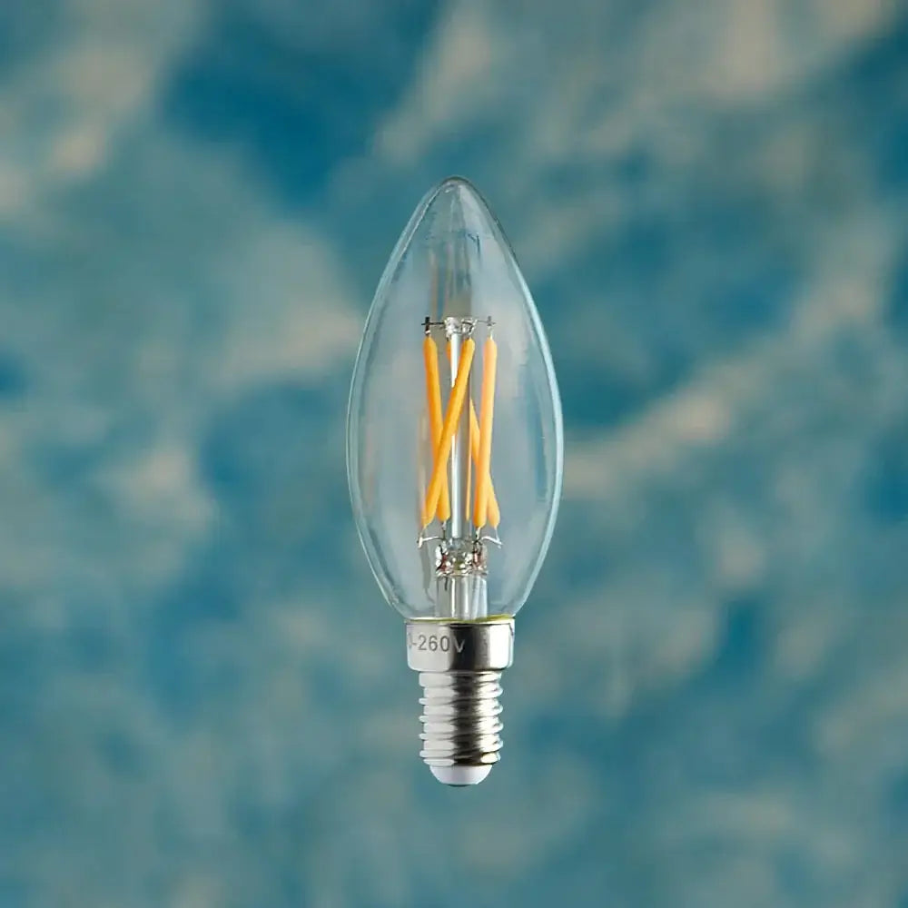 Pooky Candle 4 watt LED clear bulb with E14 screw fitting on a blue background. Classic candle lightbulb.
